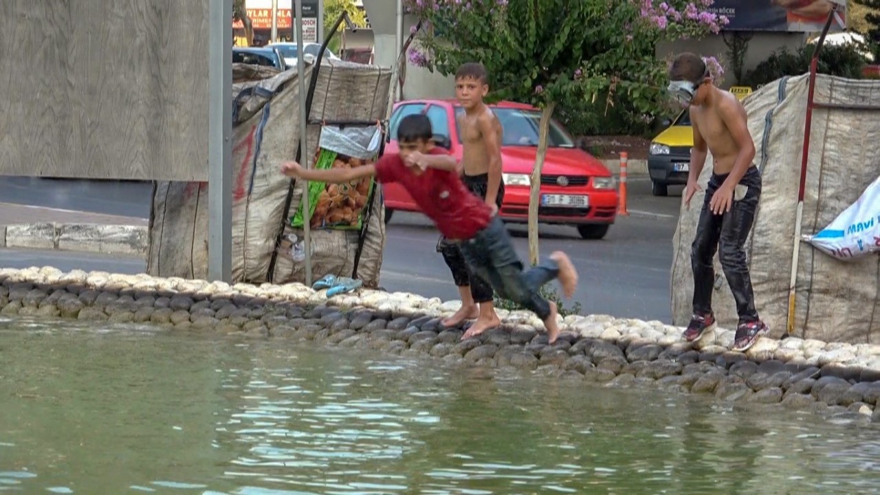 Antalya’da sıcaktan bunalan hurdacı çocuklar deniz gözlüklerini takıp soluğu süs havuzunda aldı